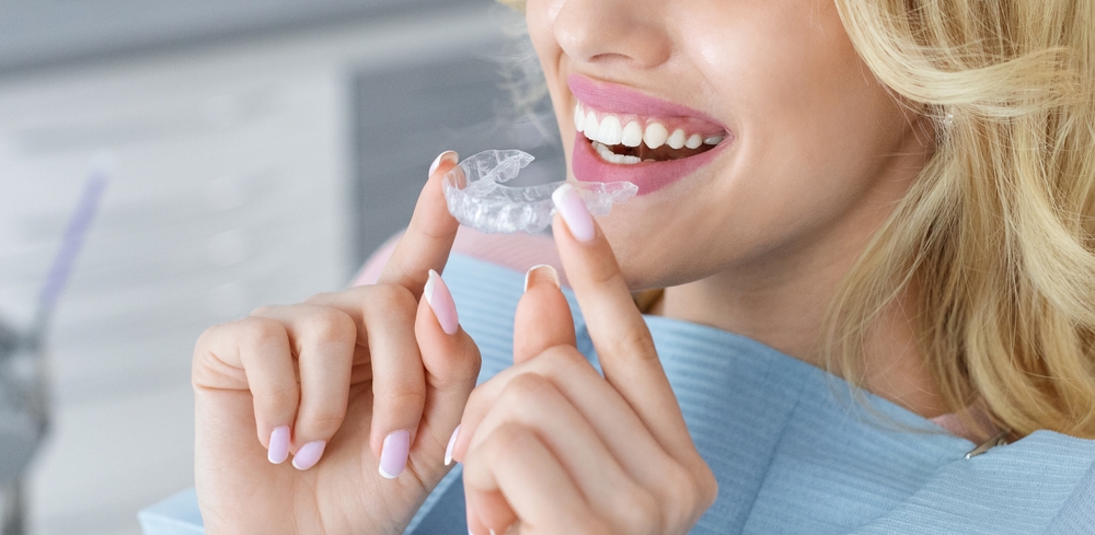 woman putting in clear aligners