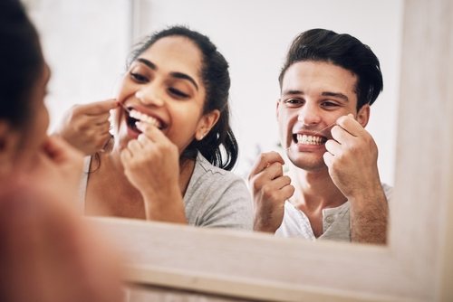 couple using dental floss